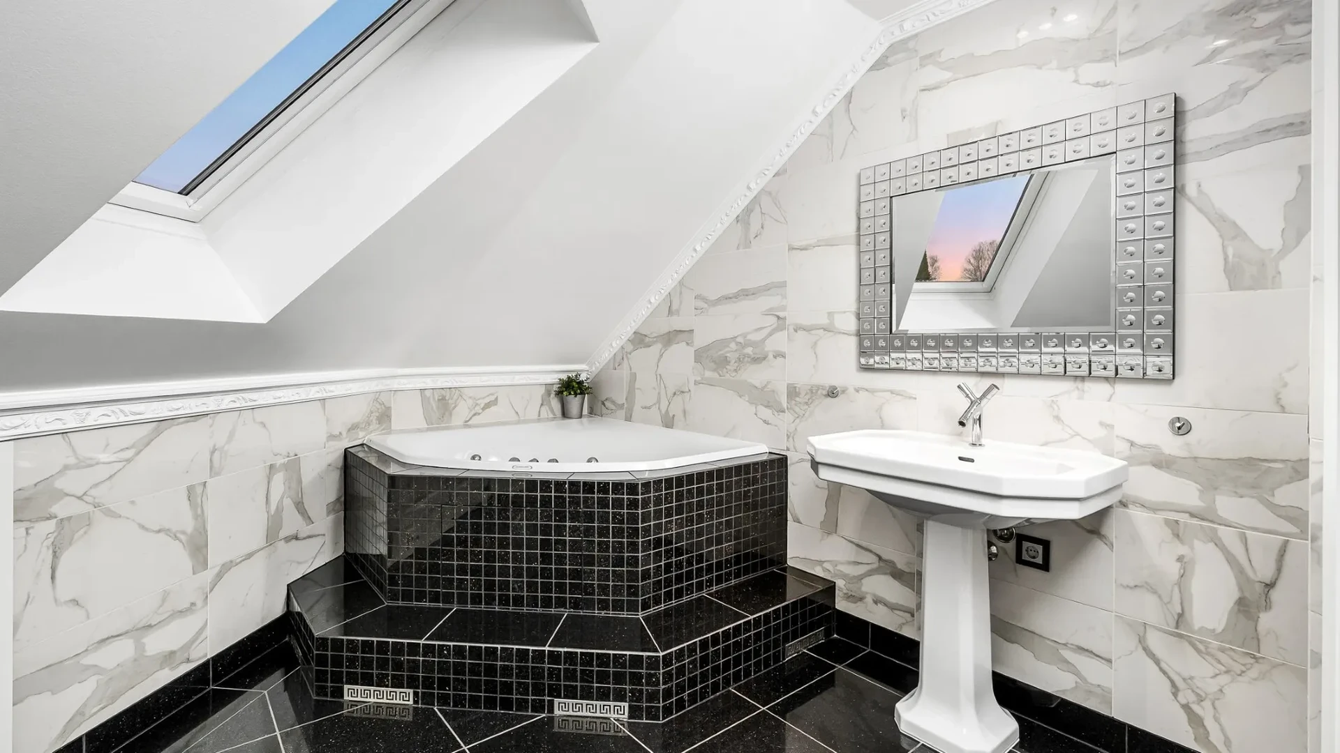Dramatic attic bathroom with black mosaic jacuzzi and marble walls