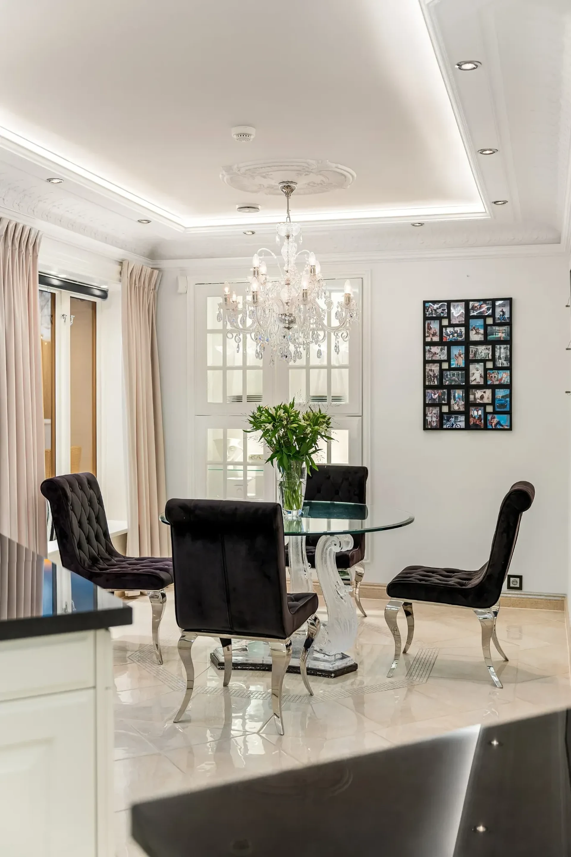 Formal dining room with black velvet chairs and crystal chandelier