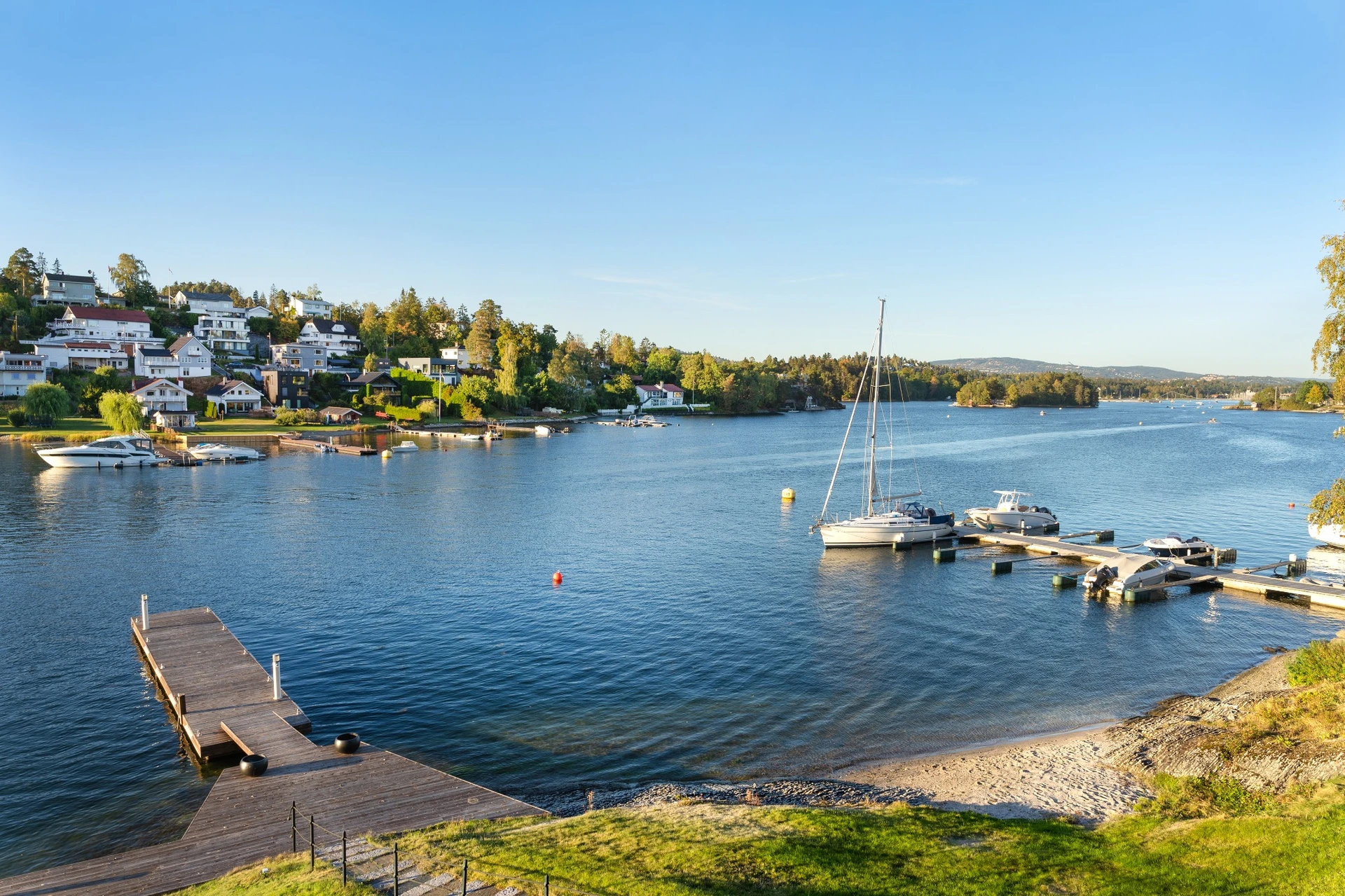 Beautiful daytime marina view with boats and waterfront homes