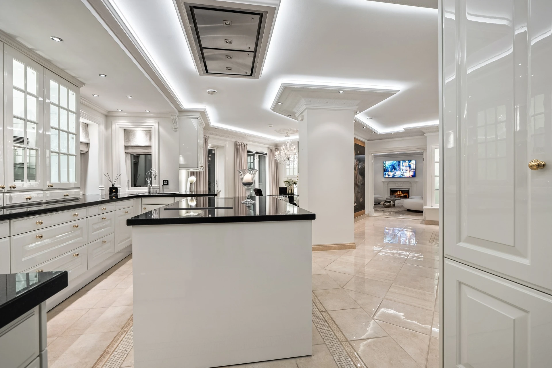 Gourmet kitchen with white cabinetry and black granite countertops