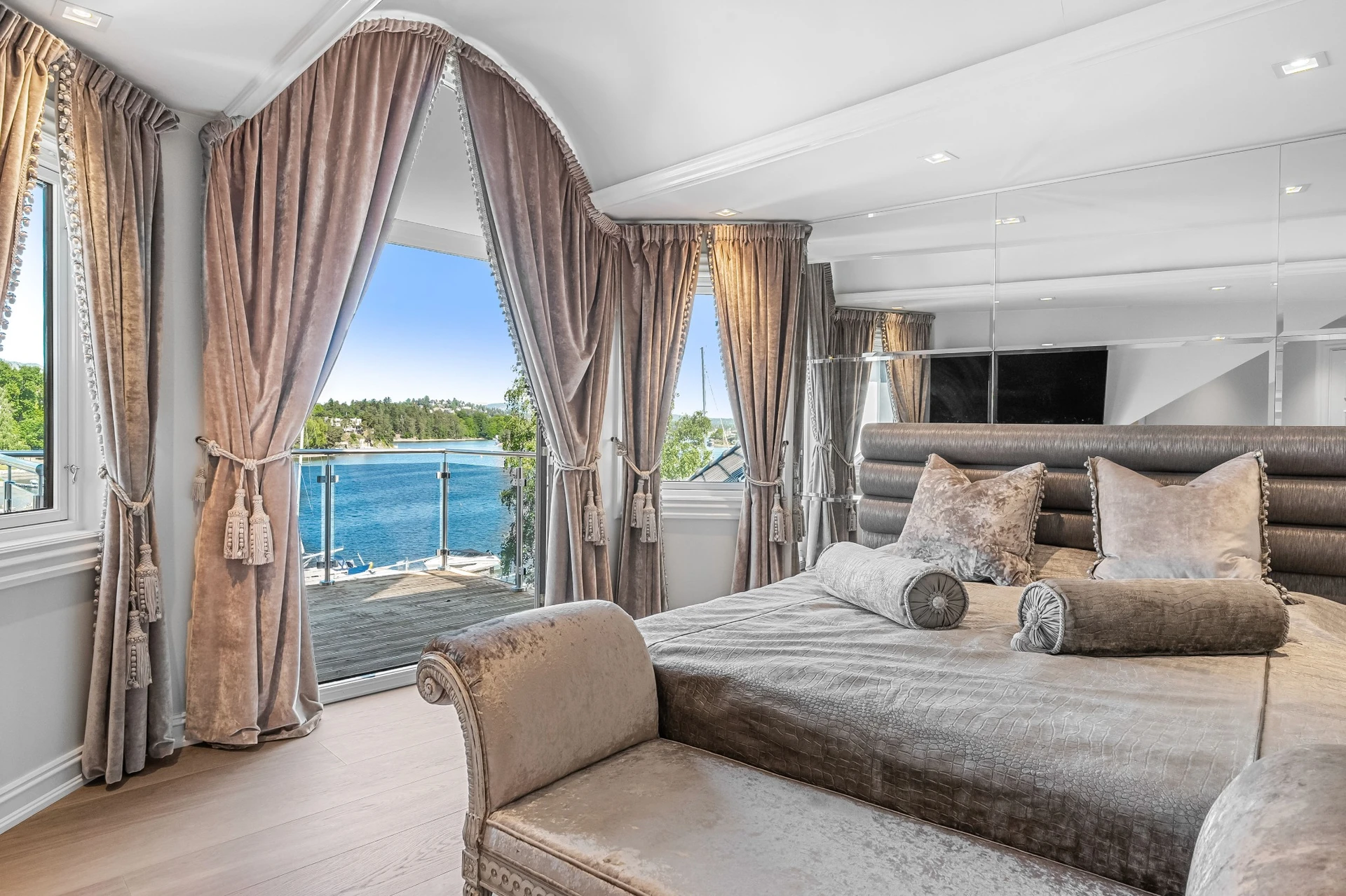 Master bedroom with waterfront access and luxury bedding
